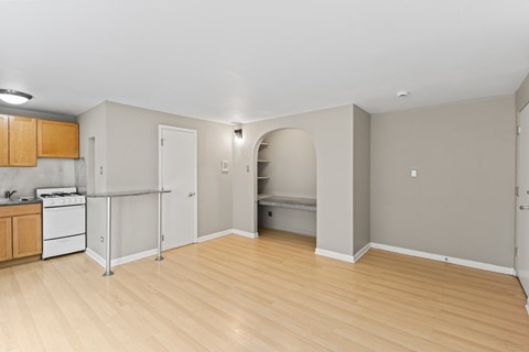 A kitchen area with a white stove and wooden cabinets.