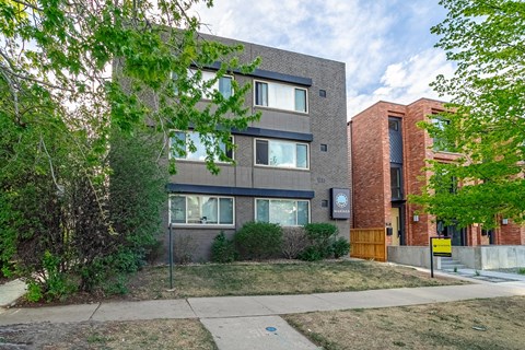 A modern building with a brick facade and a sign that says "The".