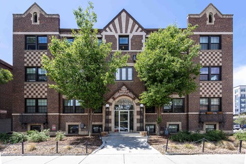 A large brick building with a checkered pattern on the windows.