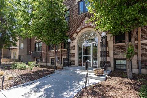 A brick building with a tree in front of it.