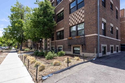 A brick building with a checkerboard pattern on the side.