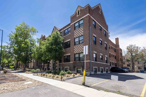 A large brick building with a checkerboard pattern on the windows.