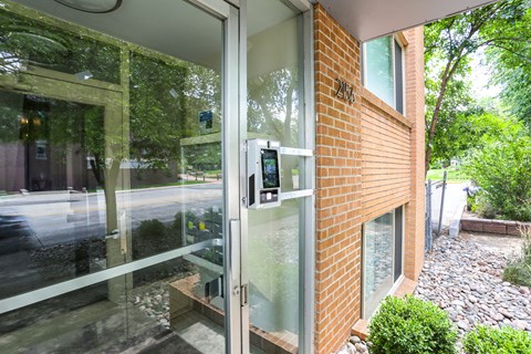 A modern house with a glass door and a brick wall.