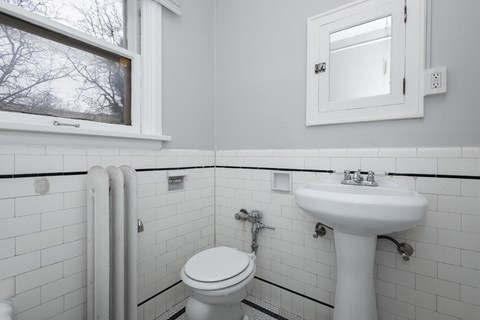 A white sink is on the counter of a bathroom.
