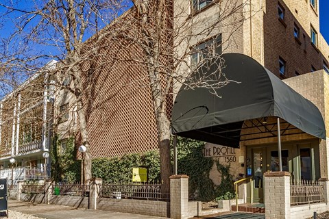 The entrance to a building with a black awning and a sign that reads "The Pro Hill".