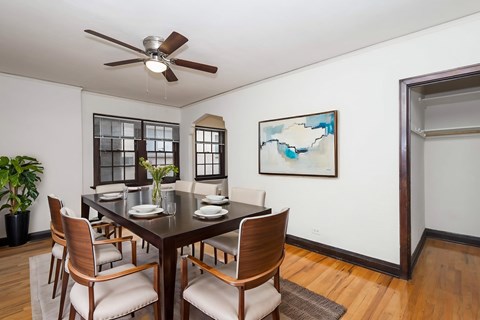 A dining room with a table set for four.