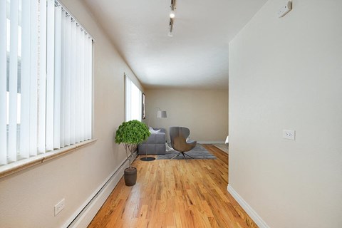 A room with a wooden floor and a chair.