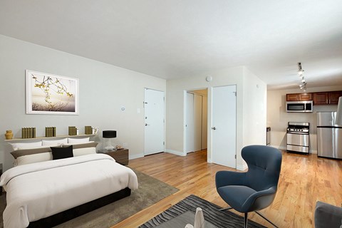 A modern bedroom with a large bed and a chair.