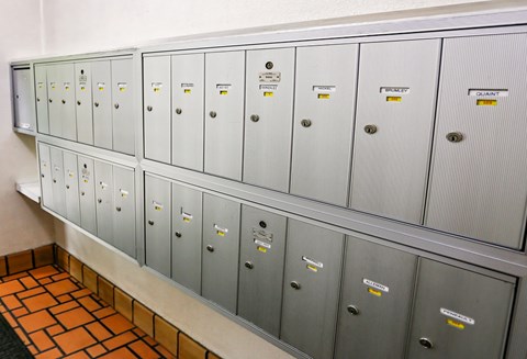 A long row of metal filing cabinets with labels on them.
