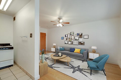 A living room with a grey couch and a blue chair.