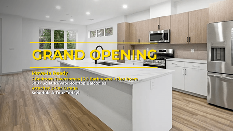 A modern kitchen with a large island and stainless steel appliances is advertised for a grand opening.