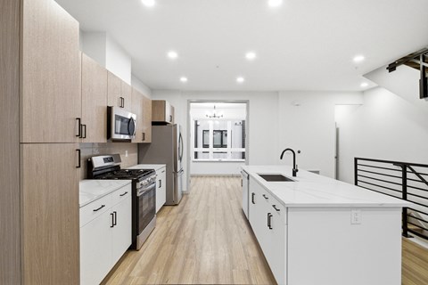 A modern kitchen with wooden cabinets and white appliances.