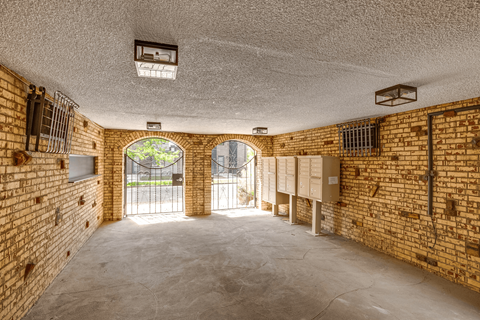 A room with brick walls and a concrete floor.
