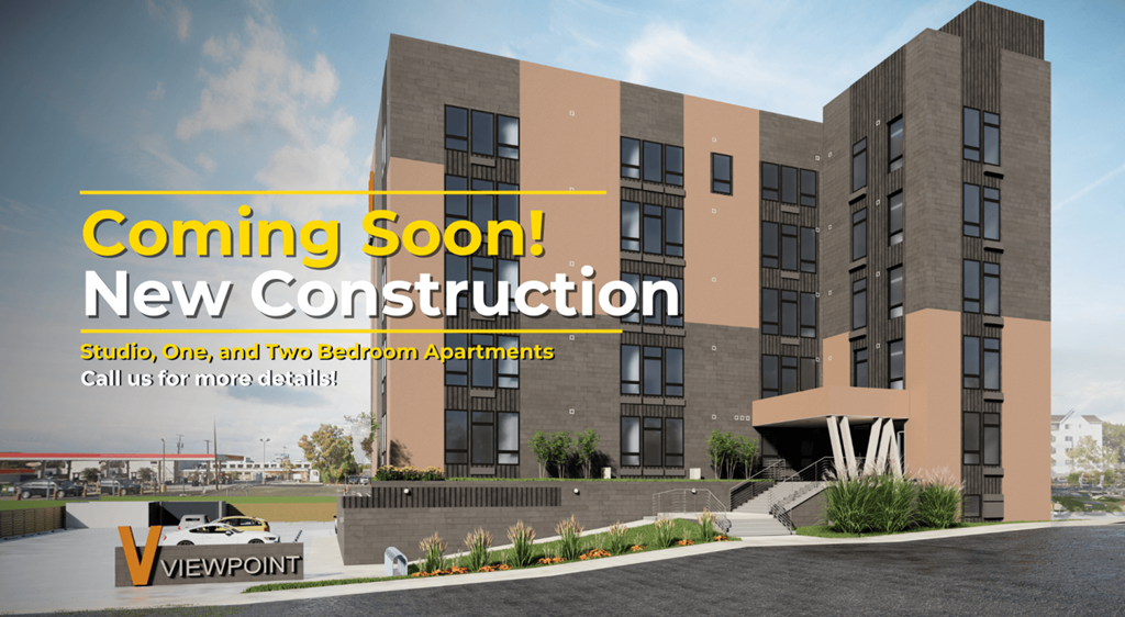 A construction advertisement for a new building with the text "Coming Soon! New Construction Studio, One, and Two Bedroom Apartments".