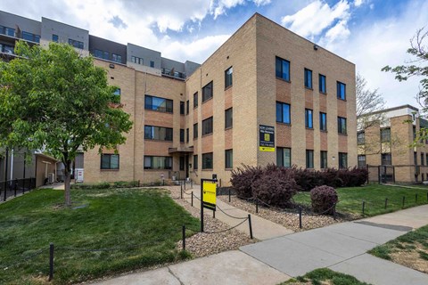 A building with a yellow sign in front of it.