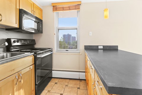 a kitchen with a counter top and a window