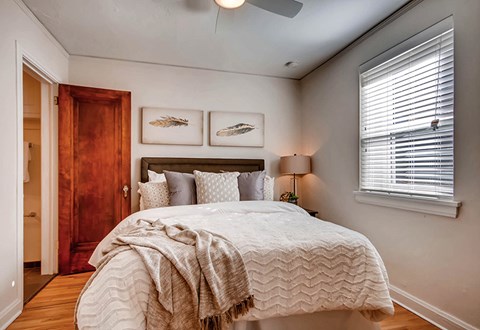 A bedroom with a large bed and a wooden door.