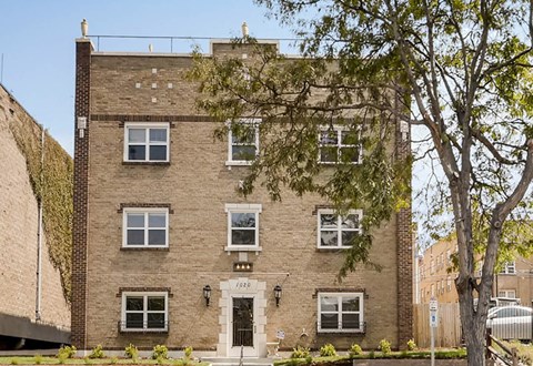 A brown building with a white door and windows.