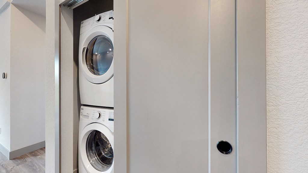 A white washing machine is in a small space.