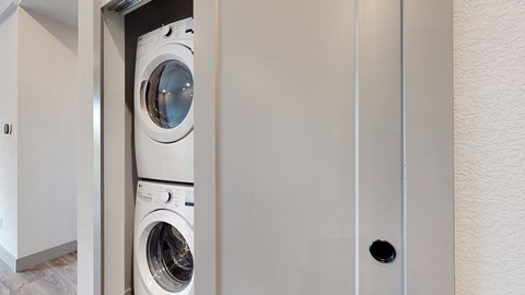 A white washing machine is in a small space.
