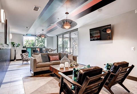 A modern living room with a wooden table and chairs.