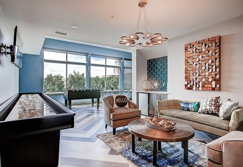A living room with a pool table and a couch.
