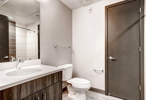 A bathroom with a white toilet and a white sink.