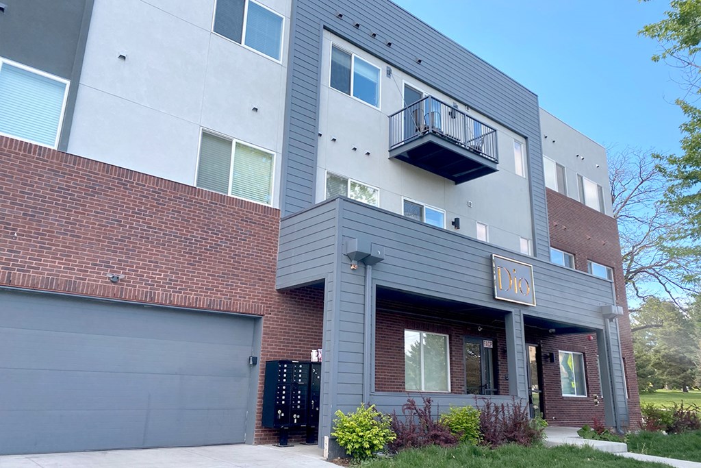 A modern building with a balcony and a garage door.