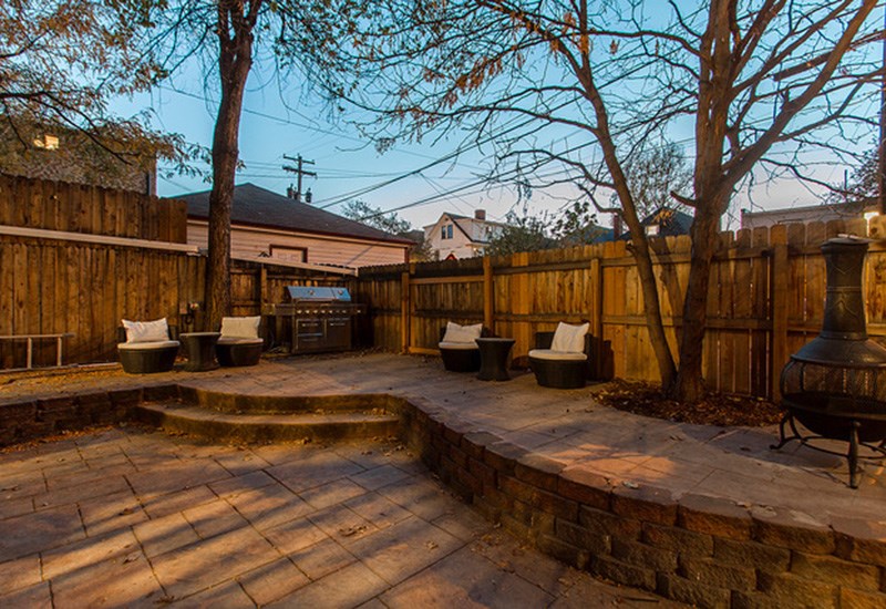 A backyard with a patio and a fire pit.