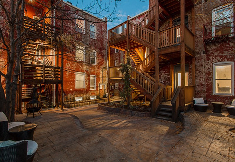 A courtyard with a staircase and a tree.