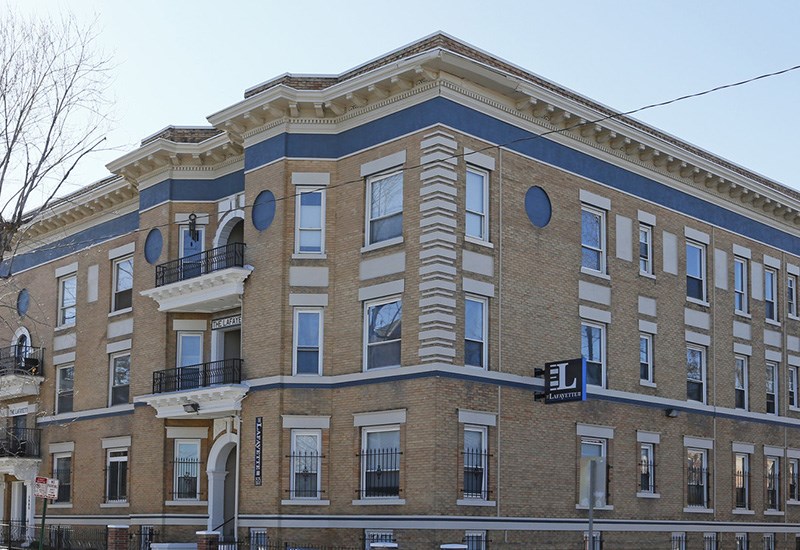 A large building with a balcony on the second floor.