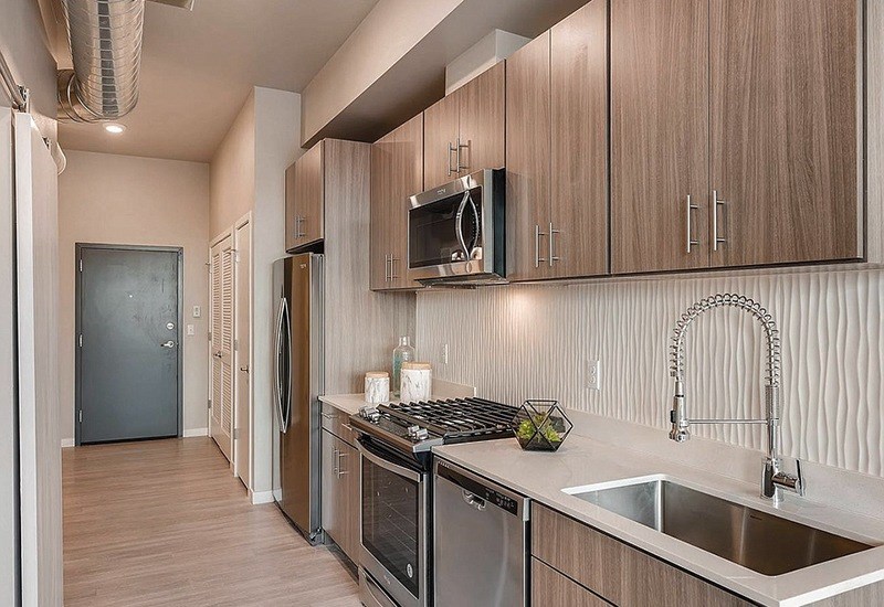 A kitchen with wooden cabinets and stainless steel appliances.