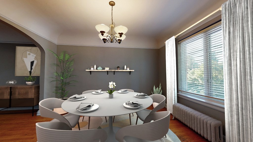 A modern dining room with a round table and chairs.
