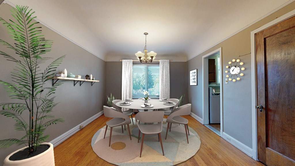 A dining room with a table set for six people.