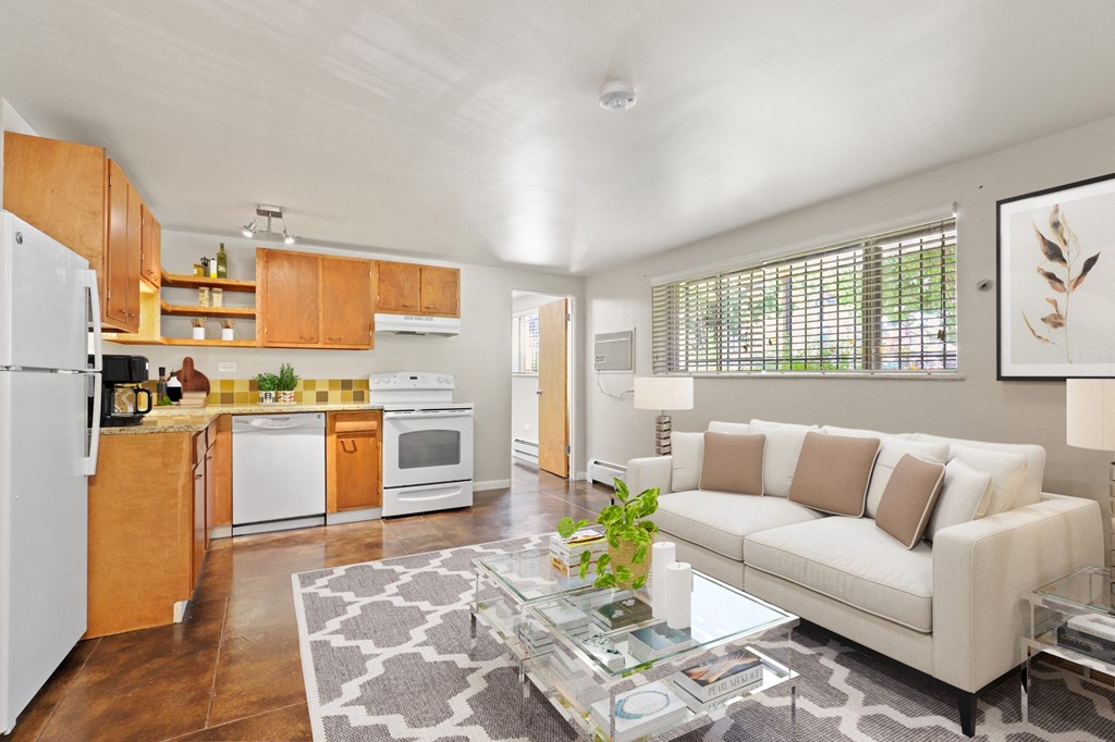a living room with a white couch and a glass coffee table