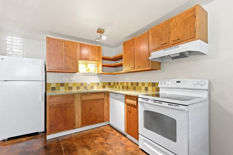 a kitchen with white appliances and wooden cabinets