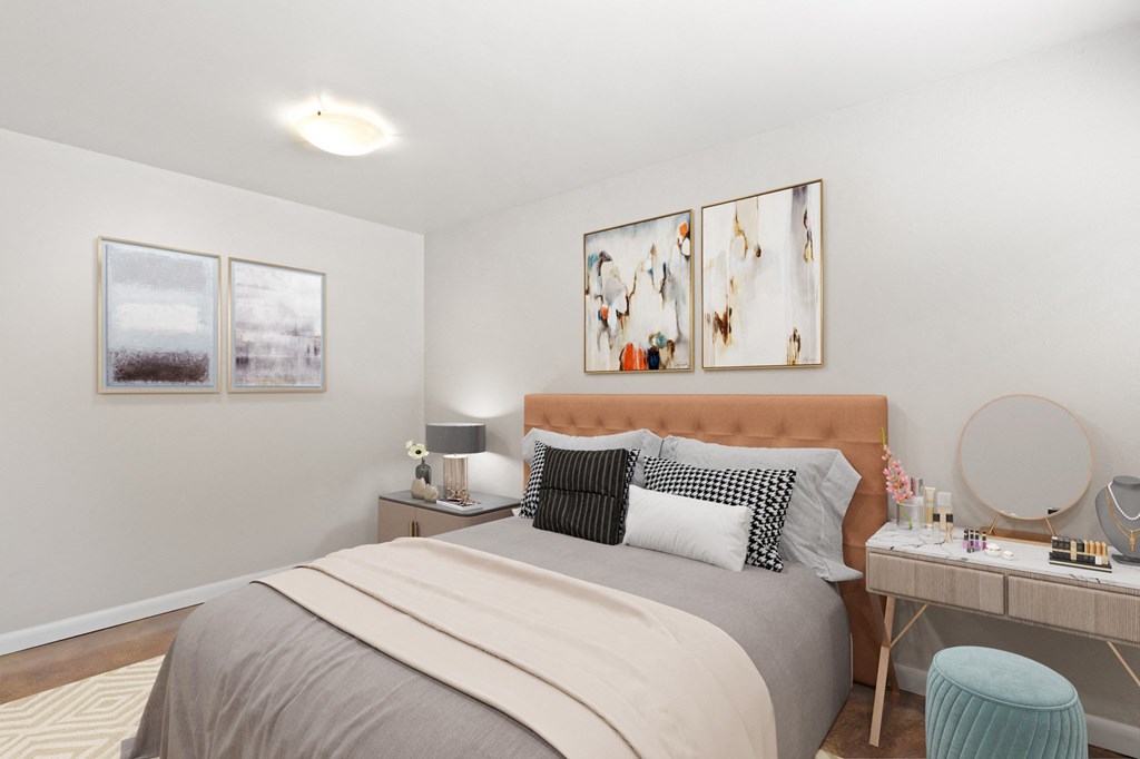 a bedroom with a bed and a desk with a mirror