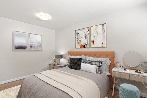 a bedroom with a bed and a desk with a mirror