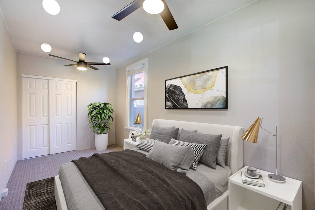 a bedroom with a bed and a ceiling fan