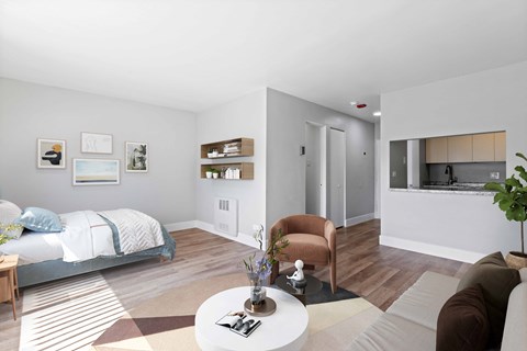 a living room with a couch and a table and a bed