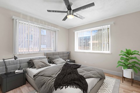 a bedroom with a large bed and a ceiling fan