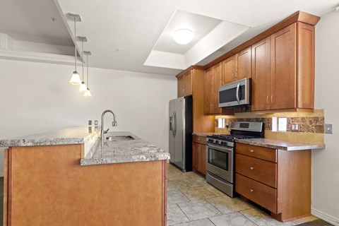 a kitchen with stainless steel appliances and wooden cabinets