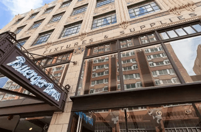 A tall building with a sign that says "Fixtures & Supplies" on it.