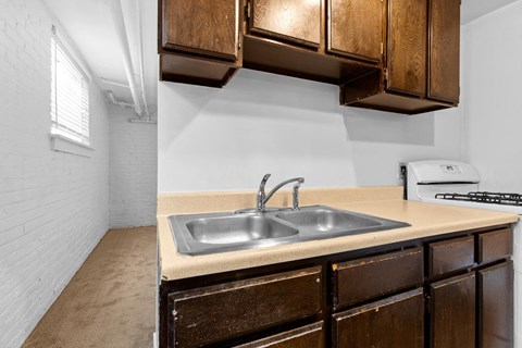 A kitchen with a sink and a toaster on the counter.