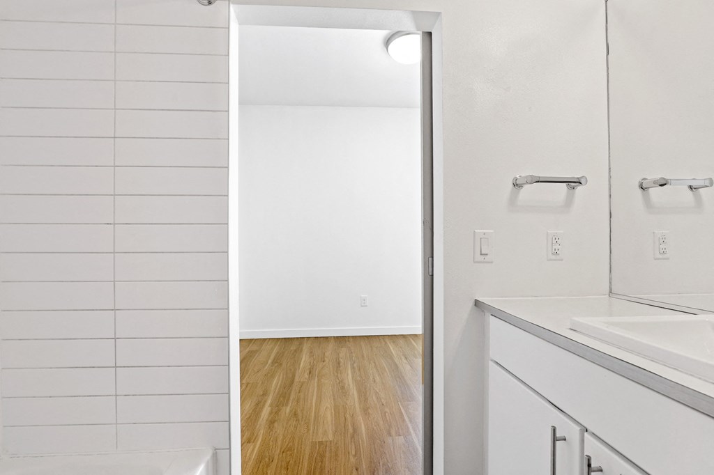 a bedroom with a medium sized bed and a mirror