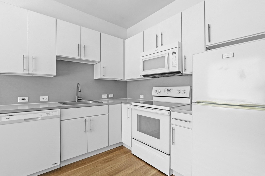 a kitchen with white cabinets and white appliances