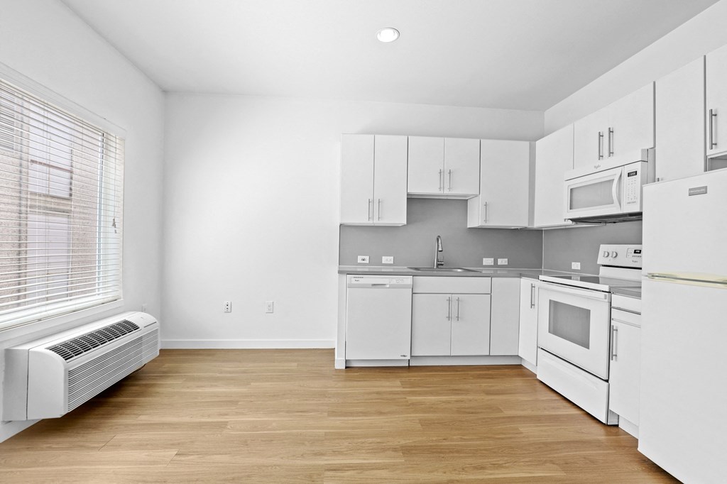 a kitchen with white cabinets and white appliances
