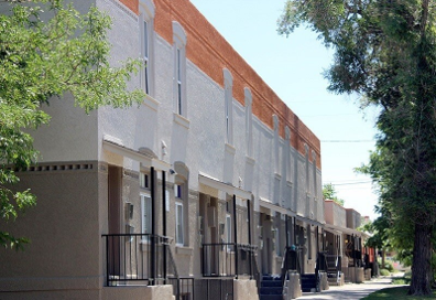 A long building with a balcony on the second floor.