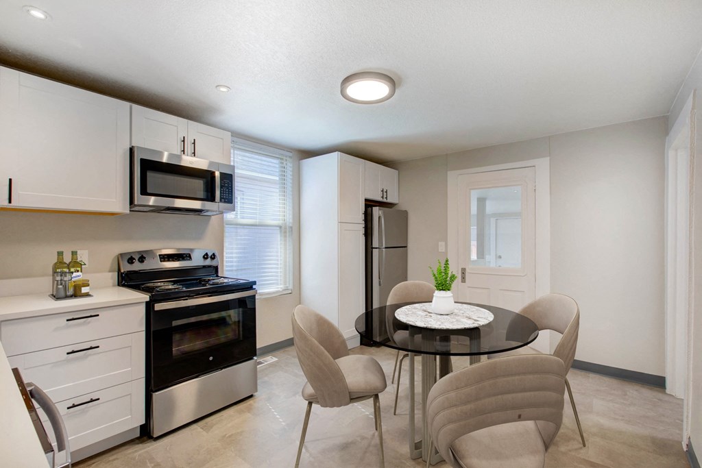 a kitchen and dining room with a table and chairs