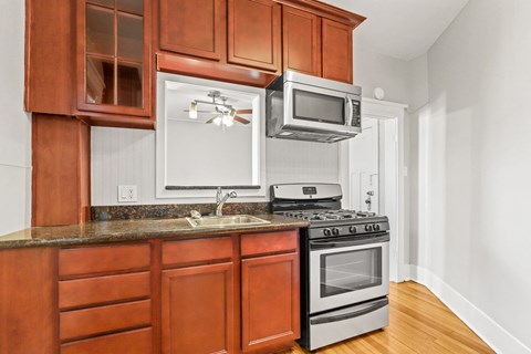 a kitchen with a sink and stove and a microwave